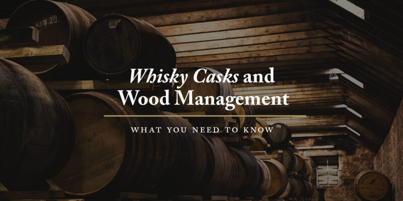 Casks of whisky stored in low ceiling distillery warehouse.